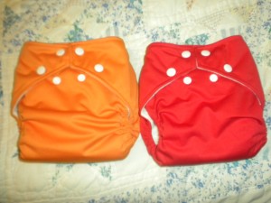 Up for grabs: Either a Kumquat (dad) or Watermelon (mom) SMALL Fuzzibunz perfect size pocket diaper. Fits 7-18 lbs (0-8 mos)
